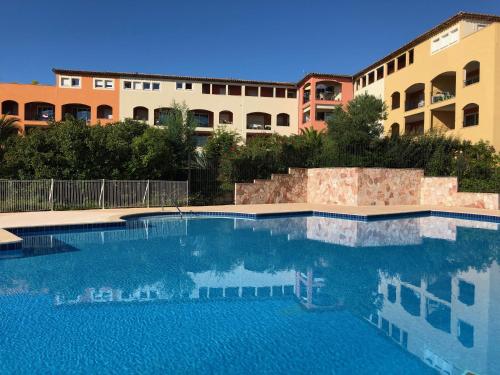 a large swimming pool in front of a building at Le Noisetier in Cavalaire-sur-Mer