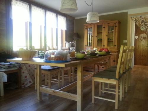 a kitchen with a large wooden table with chairs at Il Pino B&B in Alpe Devero