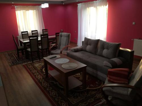 a living room with a couch and a table at Apartament u Wioli in Okleśna