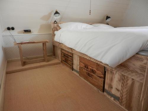 a bedroom with a bed made out of wood at Bed&Breakfast ons Oda in Sint-Oedenrode