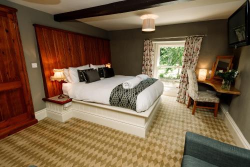 a bedroom with a bed and a window at The Rectory Rooms, Studio 3 in Skipton