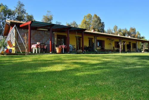 a house with a lawn in front of it at Agriturismo Monte Majore in Siliqua