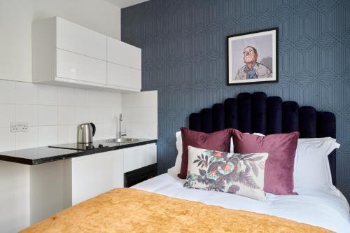 a bed with a black headboard in a room at Sonder St Johns Garden in London