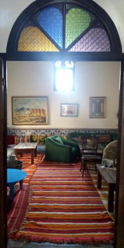 a living room with a couch and a rug at dar said in Rabat
