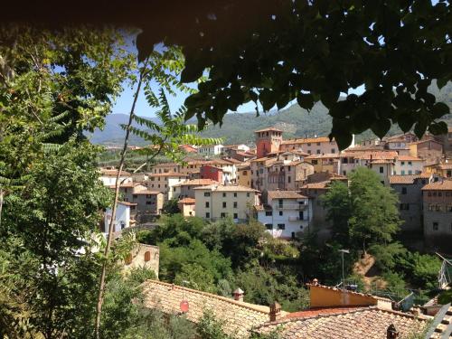 a town on a hill with buildings at Hotel Le 3 Fonti in Loro Ciuffenna