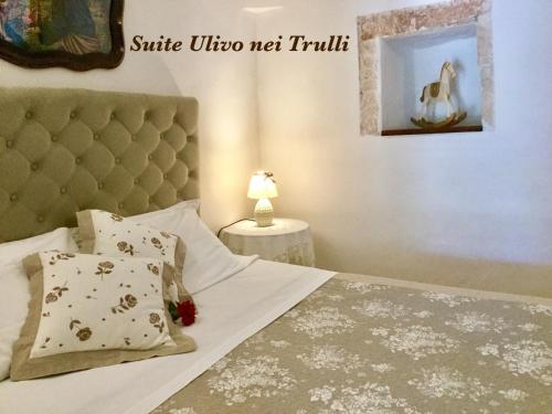 a bedroom with a bed with a headboard at Mirella Charming in Alberobello
