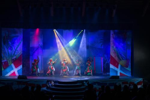 a group of performers on a stage with lights at Casa Marina Beach & Reef All Inclusive in Sosúa