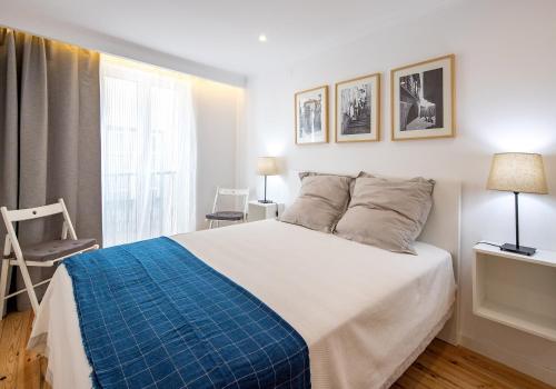 a bedroom with a large bed and a window at Lisbon For You Apartment in Lisbon