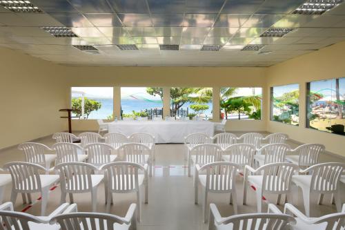 a room with rows of white chairs and a table at Casa Marina Beach & Reef All Inclusive in Sosúa