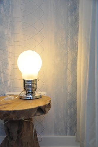 a lamp on a wooden table in a bathroom at Six! Eat Work Sleep in Brühl
