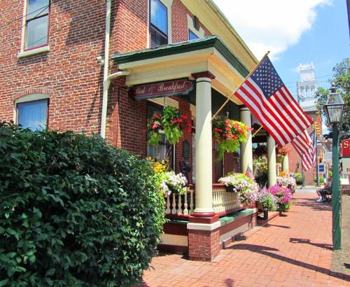 a building with an american flag in front of it at Strasburg Village Inn in Strasburg