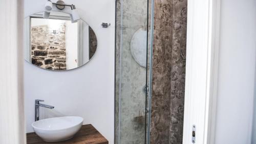 a bathroom with a sink and a mirror at Antico Borgo dei Templi in Agrigento