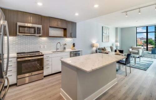 an open kitchen and dining room with a counter top at Global Luxury Suites Bethesda Chevy Chase in Bethesda