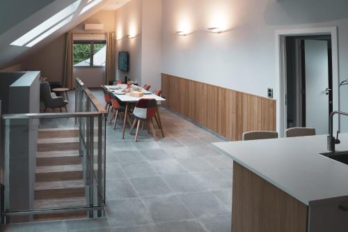 a kitchen and dining room with a table and chairs at Open Source à l'entrée du Circuit! in Stavelot