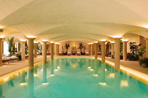 a large swimming pool in a hotel lobby at Grantley Hall in Ripon
