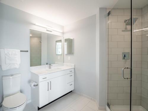 a bathroom with a toilet and a sink and a shower at Global Luxury Suites Bethesda Chevy Chase in Bethesda