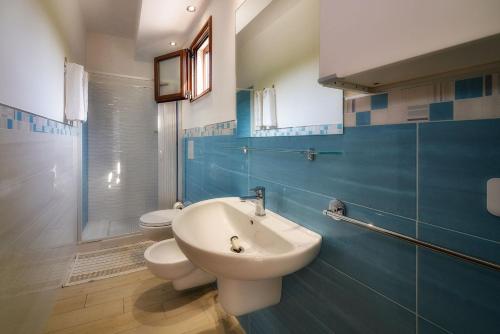 a bathroom with two toilets and a sink at Residence Palm Beach in Peschici