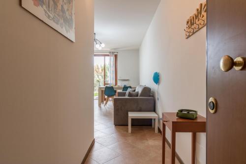 a living room with a couch and a chair at A casa di Laura with pool and free bikes in Ronchi