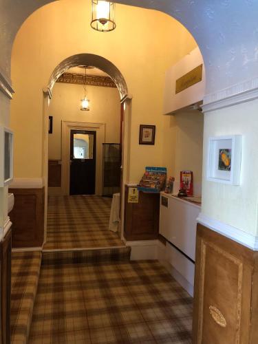 a hallway with an archway leading to a room at The Purple Tree Guest House in Torquay