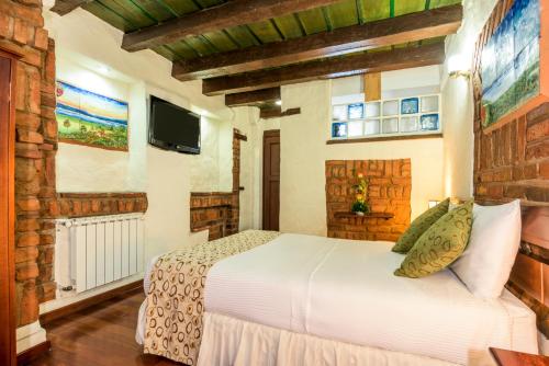 TV a/nebo společenská místnost v ubytování Hotel Muisca