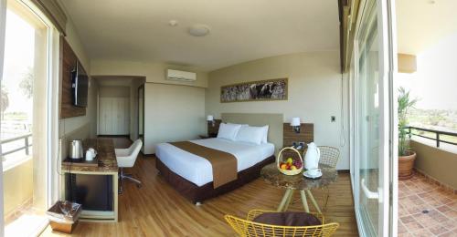 a hotel room with a bed and a balcony at DM Hoteles Moquegua in Moquegua