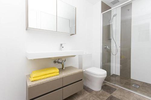 a bathroom with a sink and a toilet and a shower at AAC Apartments - Manhattan in Canberra