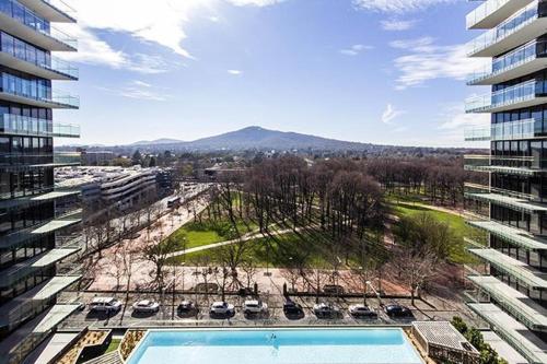 arial view of a building with a swimming pool at AAC Apartments - Manhattan in Canberra