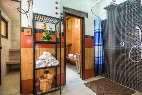 a bathroom with a shower and a glass door at Hotel Muisca in Bogotá