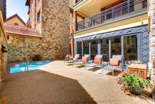 a patio with chairs and a swimming pool at Relais & Chateaux Lumiere by Dunton in Telluride