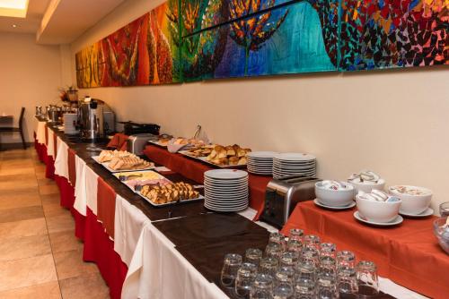a buffet line of tables with food on them at Icaro Suites in Buenos Aires