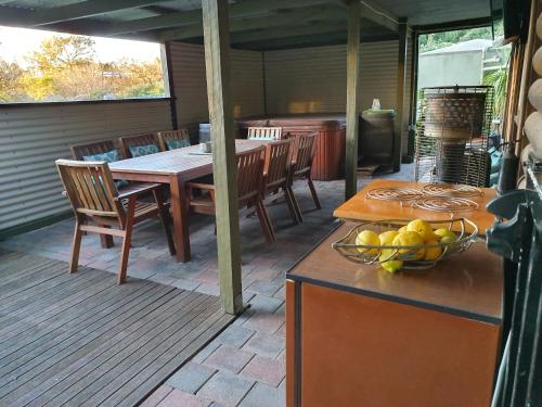 a patio with a table and chairs on a deck at Angaston by the Winter Creek in Angaston
