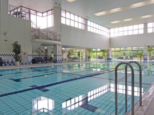 a large swimming pool in a large building at Hotel Epinard Nasu in Nasu