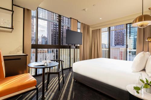 een hotelkamer met een bed en een groot raam bij Brady Hotels Jones Lane in Melbourne