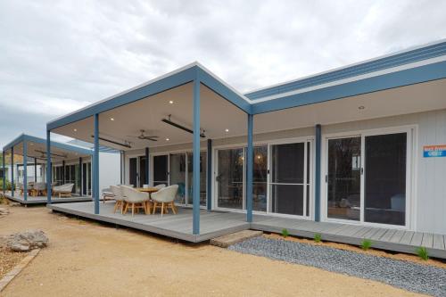 a modular home with a blue roof and a patio at NRMA Tathra Beachfront Holiday Park in Tathra