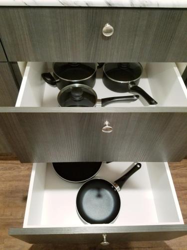 a cabinet with pots and pans on a stove at Kanab Suites in Kanab