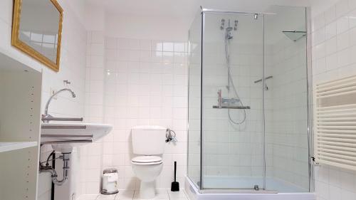 a bathroom with a shower and a toilet and a sink at Hamburg/Berlin Hamburg App. 106 in Großenbrode