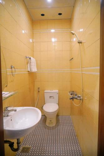 a bathroom with a sink and a toilet and a shower at Dai A Hotel in Da Nang