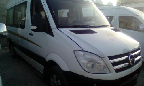 a white van is parked in a parking lot at Rolando share apart in Punta Cana