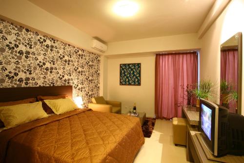 Cama o camas de una habitación en Rasuna Mansion