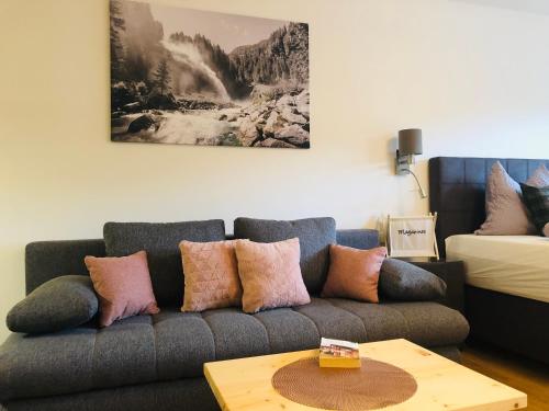 a living room with a couch with pillows on it at Julia in Kaprun