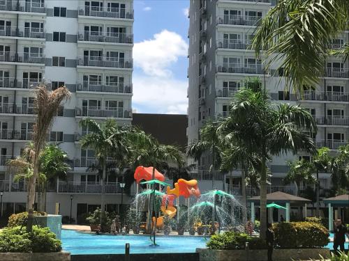 a water park in front of some tall buildings at StayCation Dream CondoTel in Manila