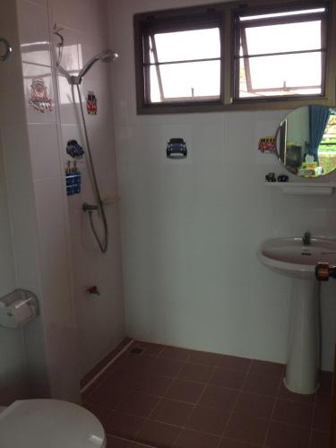 a bathroom with a shower and a toilet and a sink at Loy Manee House in Phra Nakhon Si Ayutthaya