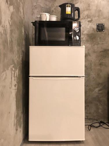 a microwave sitting on top of a refrigerator at Villa Gazamani Aug,2019 Open!! For only one group a day in Yaese