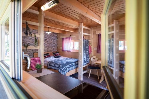 a bedroom with a bed in a small room at Camping Danica Cottage Stan in Bohinj