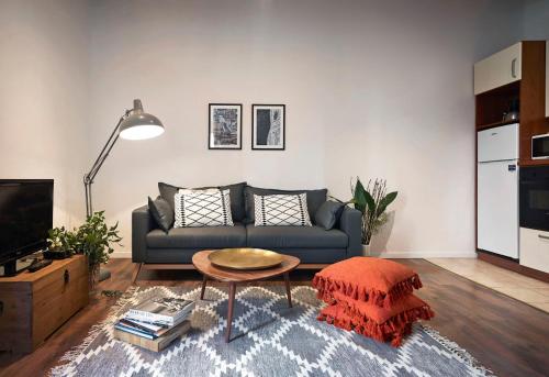 a living room with a couch and a table at Great Apts Few Steps to The Duomo in Florence