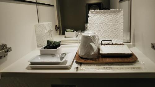 a counter top with a cutting board and other items on it at Restay Hiroshima (Adult Only) in Hiroshima