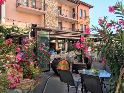 a patio with flowers and tables and chairs at Oleander House and Tennis Club in Sunny Beach