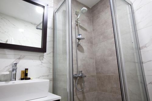 a bathroom with a shower and a sink at Siete Hotel in Antalya