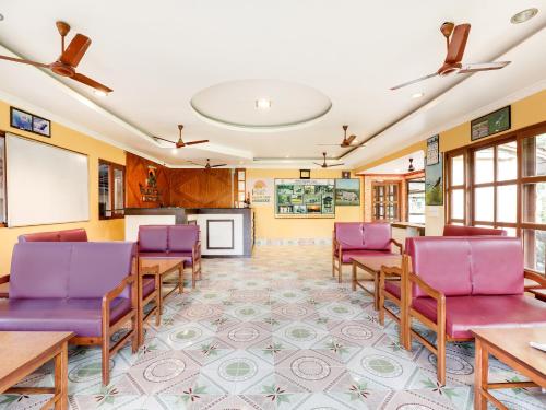 a conference room with purple chairs and a table at Hotel Wildlife Camp in Sauraha