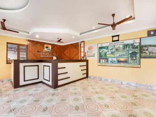a living room with a ceiling fan and a counter at Hotel Wildlife Camp in Sauraha